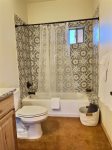 Guest bathroom tub, toilet and vanity